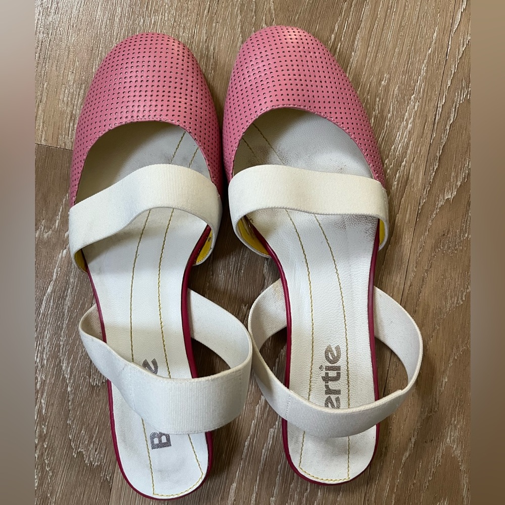 Pink open-back flats with white straps